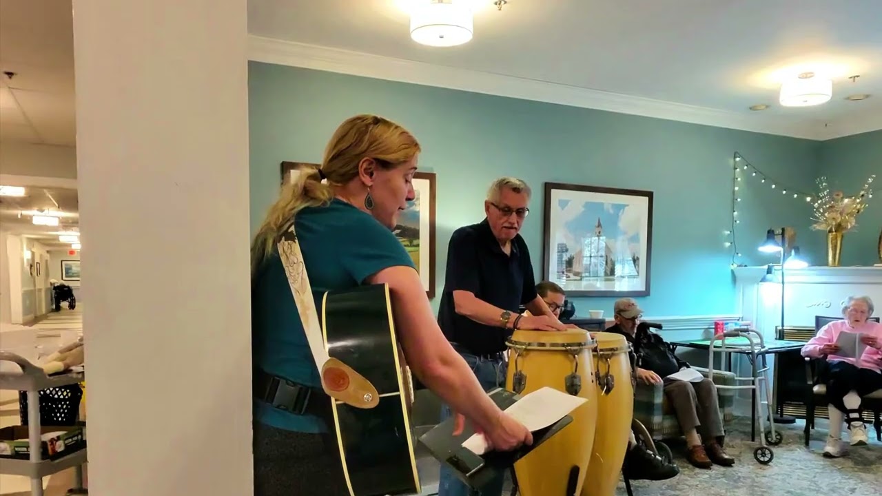 having fun with socks/April, Kenny, and Ruth singing, and playing music.
