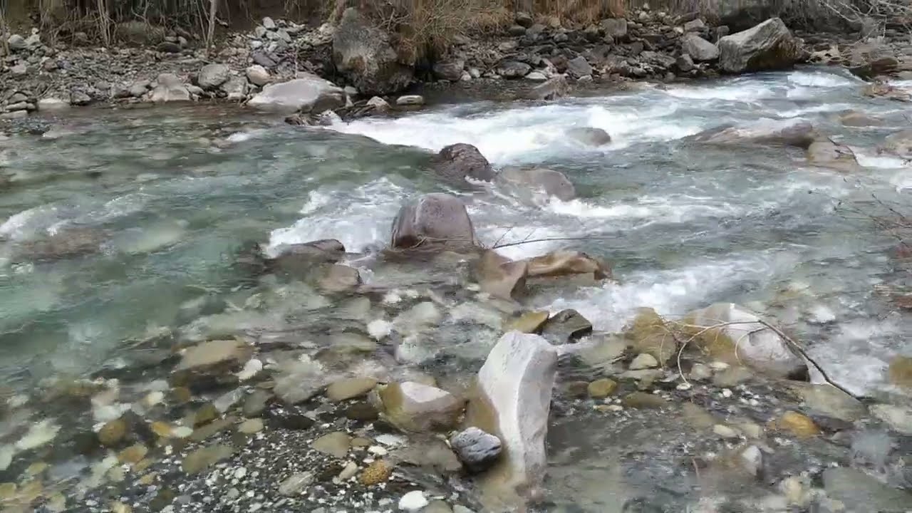 Clear river among snowy mountains #mountains #river #livecontent #subscribe #like