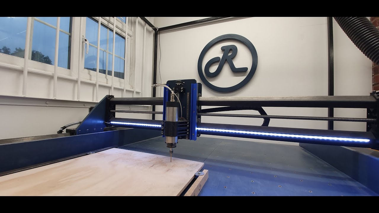 Root 4 3D Printed CNC machine cutting its own logo in plywood