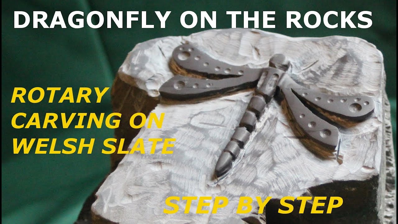 Stone carving. Dragonfly on the rocks, rotary carving on Welsh slate rockery.