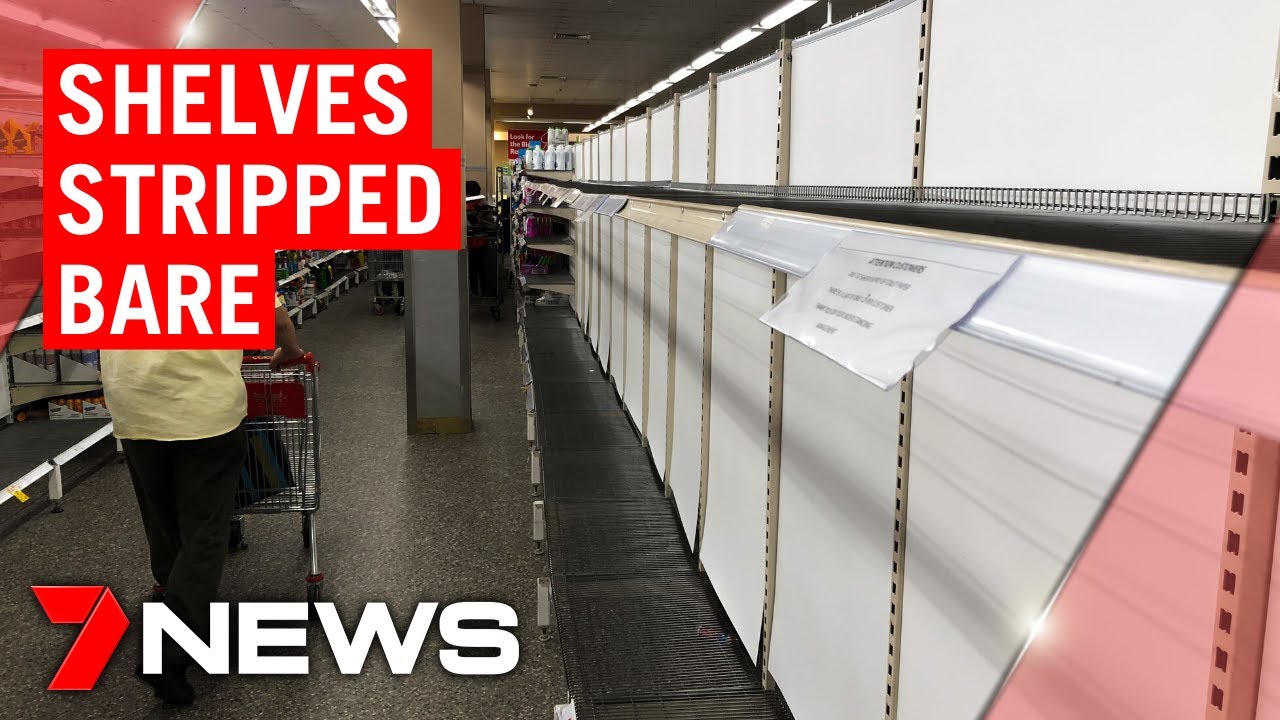 Shelves stripped bare: panic buying continues to empty stores | 7NEWS