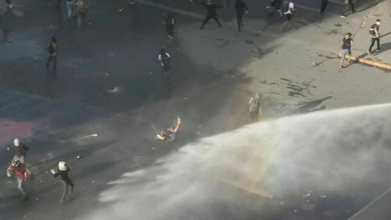 Police hit protesters in Santiago, Chile with water cannons | AFP