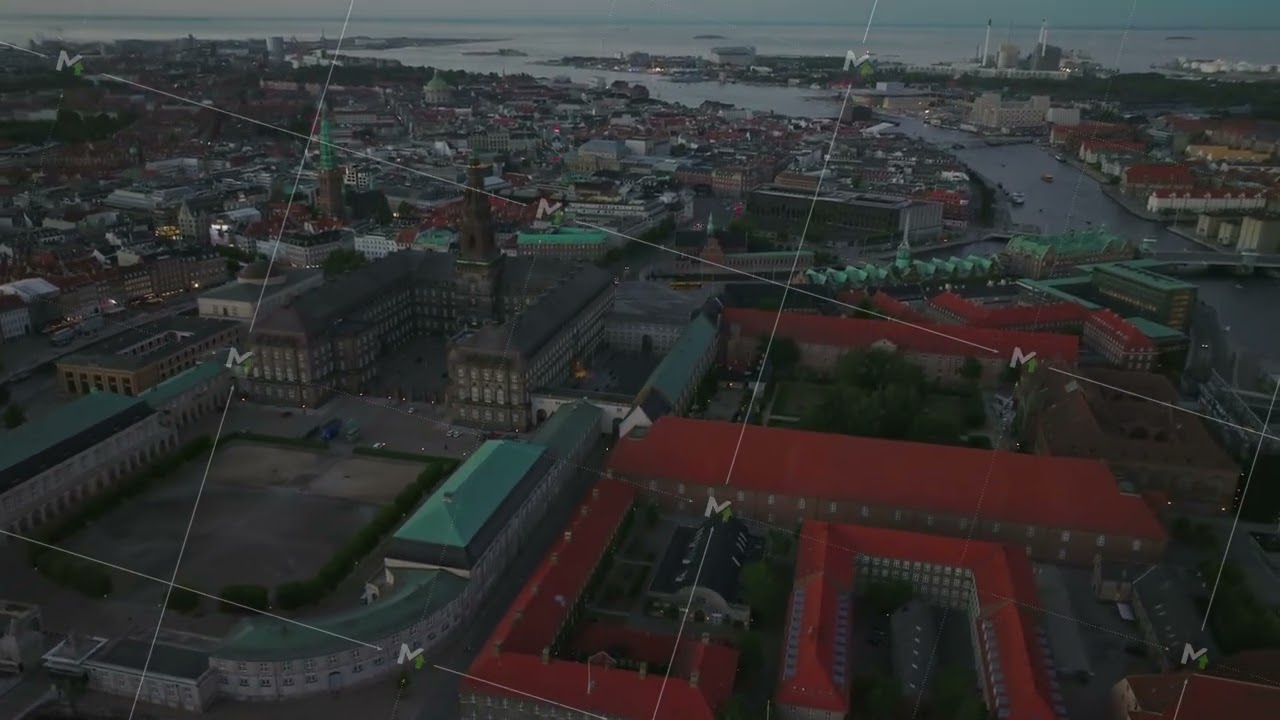 Christiansborg, War museum and Borsen buildings on Slotsholmen island from height. Tilt up reveal of