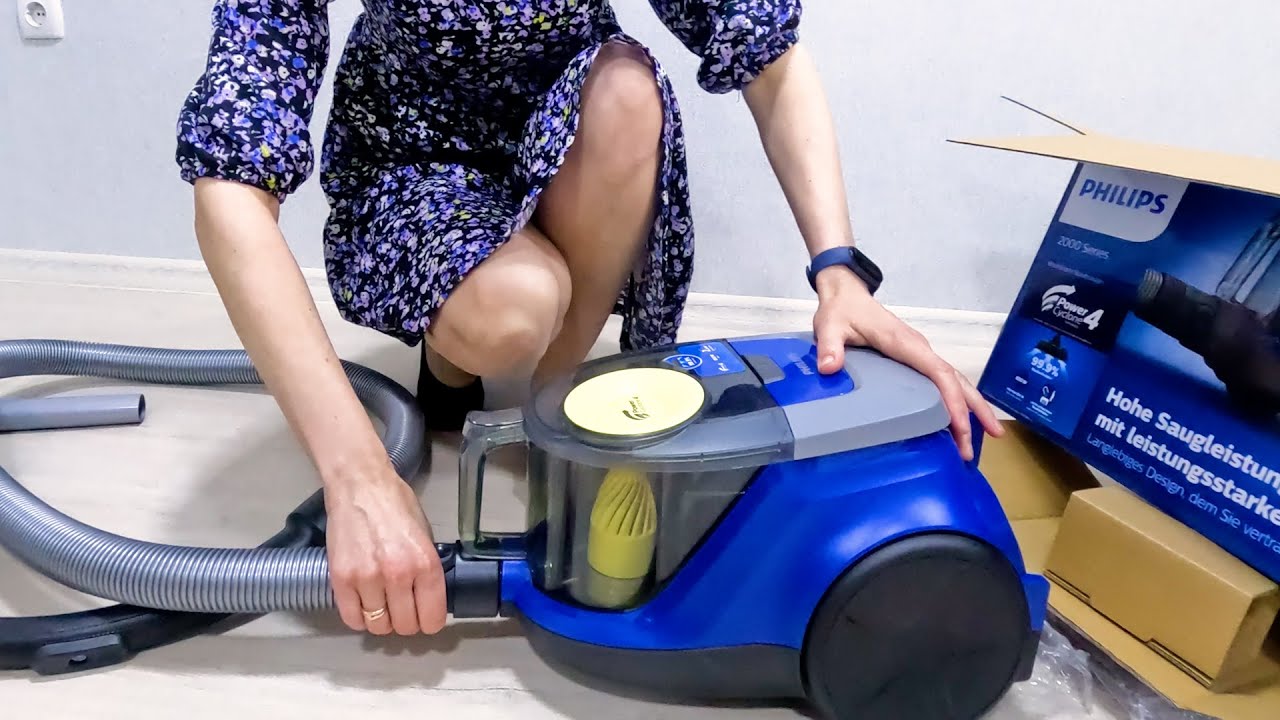 Unpacking the Philips 2000 Series XB2125/09 Bagless Vacuum Cleaner. First test. A girl in a dress