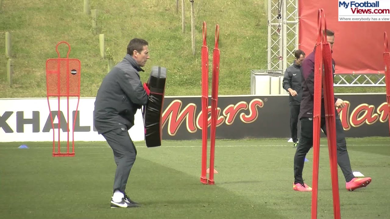 Wayne Rooney powers through rugby tackle-bag in training