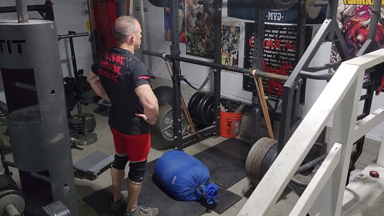EMOM Sandbag over bar