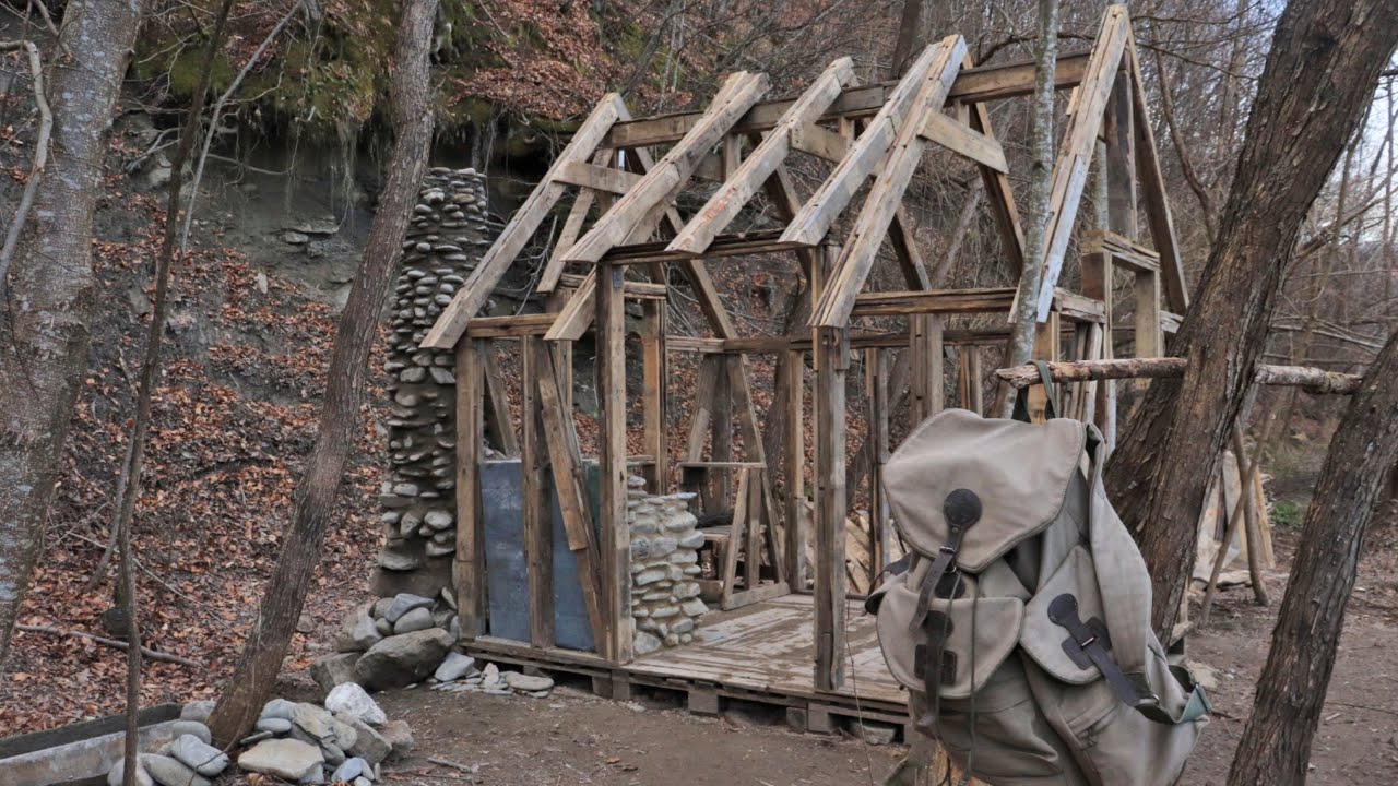 Building a house from pallets near the river