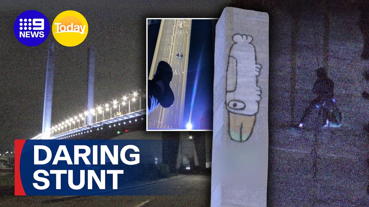Graffiti daredevil scales Melbourne bridge and hangs mid‑air in wild stunt | 9 News Australia