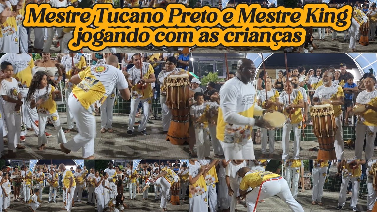 Mestre Tucano Preto e Mestre King jogando com as crianças da Escola de Capoeira Ginga Menino 
