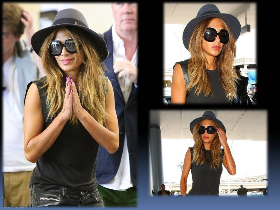 Nicole's sheer tank top featured leather sleeves and showcased a hint of her matching black top and