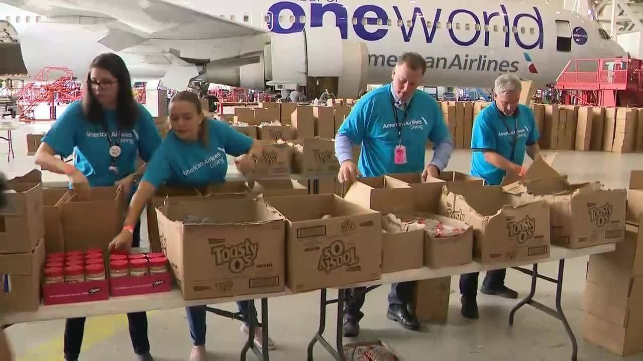 American Airlines employees pack up boxes of food for Hurricane Irma victims
