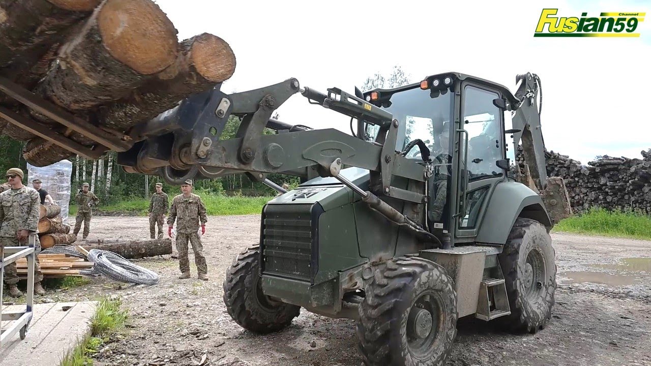 Cat Backhoe Working to Move Logs for Sawing in Liepaja, Latvia