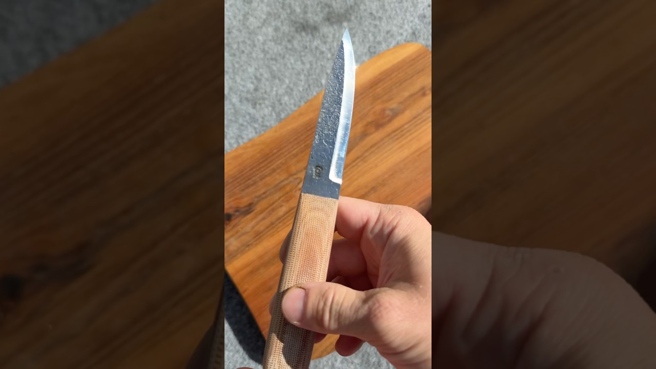 Modern puukko with handforged blade and natural canvas micarta handle. It&rsquo;s for sale.