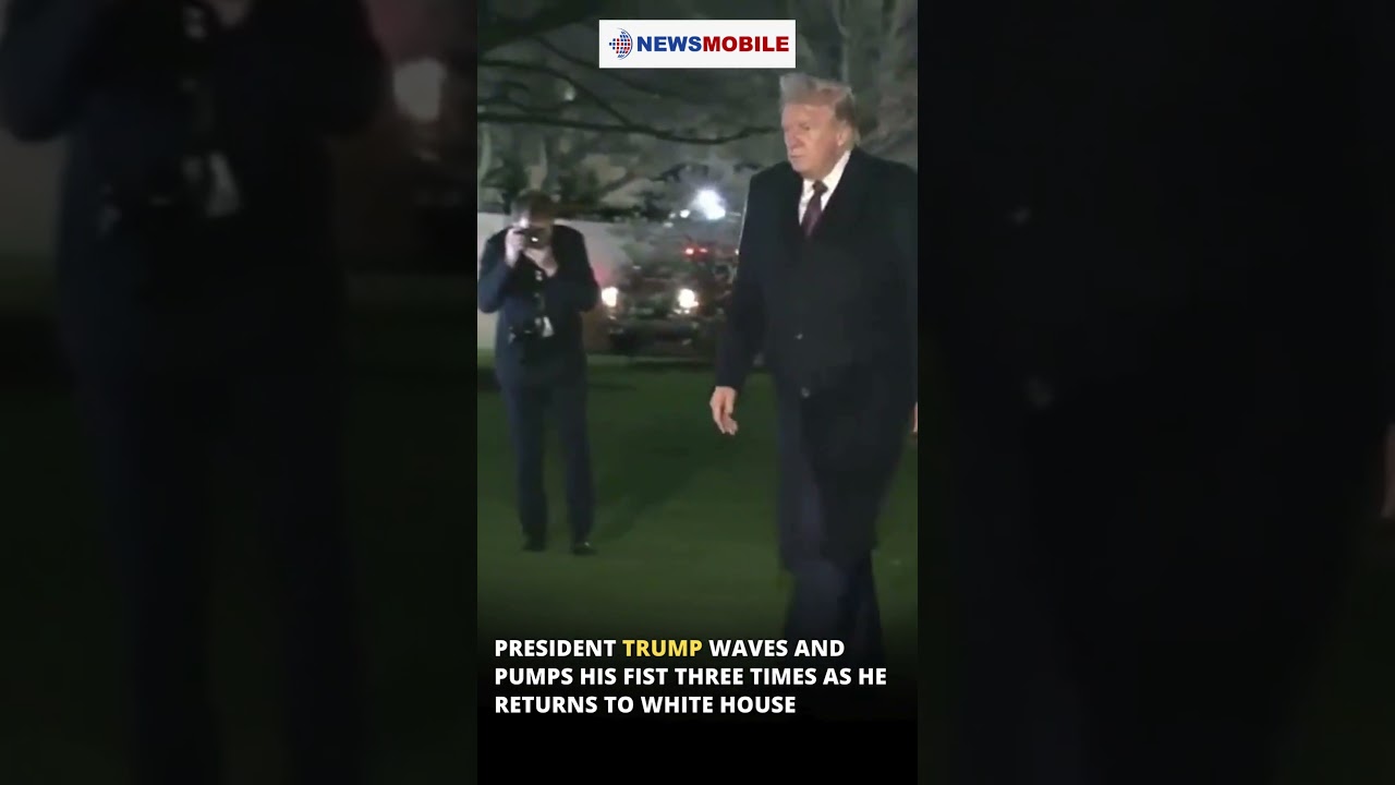 President Trump waves and pumps his fist three times as he returns to White House