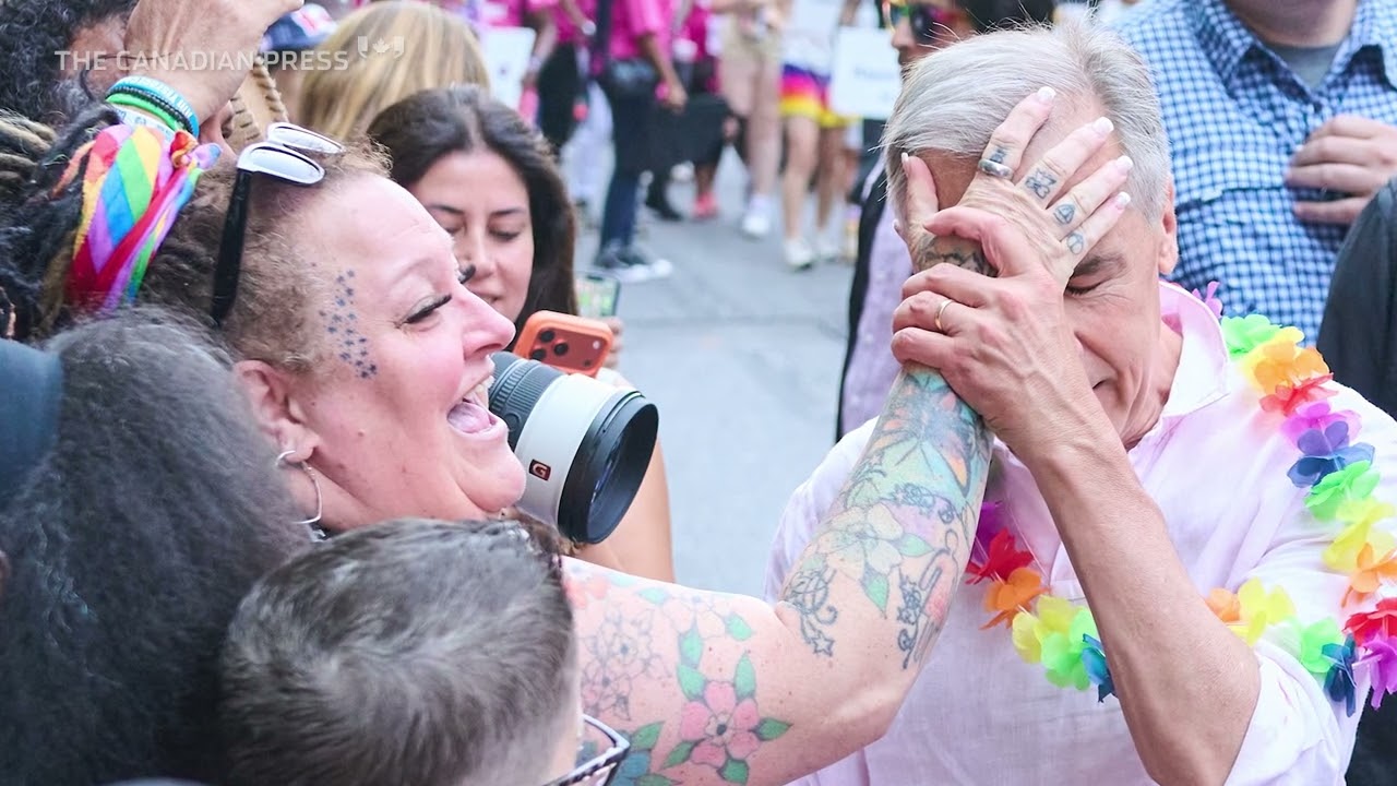 Revellers douse Carney with water at Toronto Pride