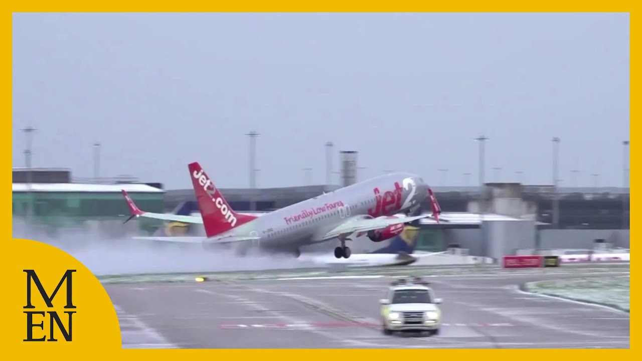 Snowy conditons at Manchester Airport as planes take off and land
