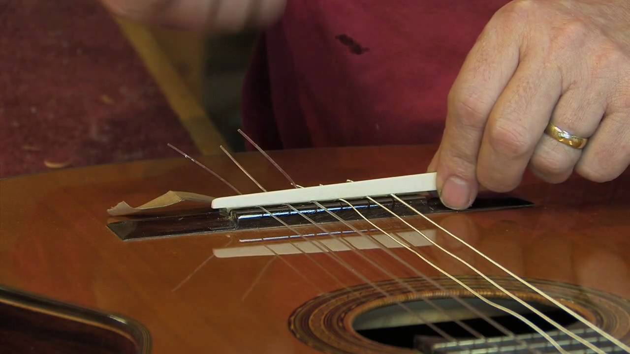 Adjustable saddle for classical guitar