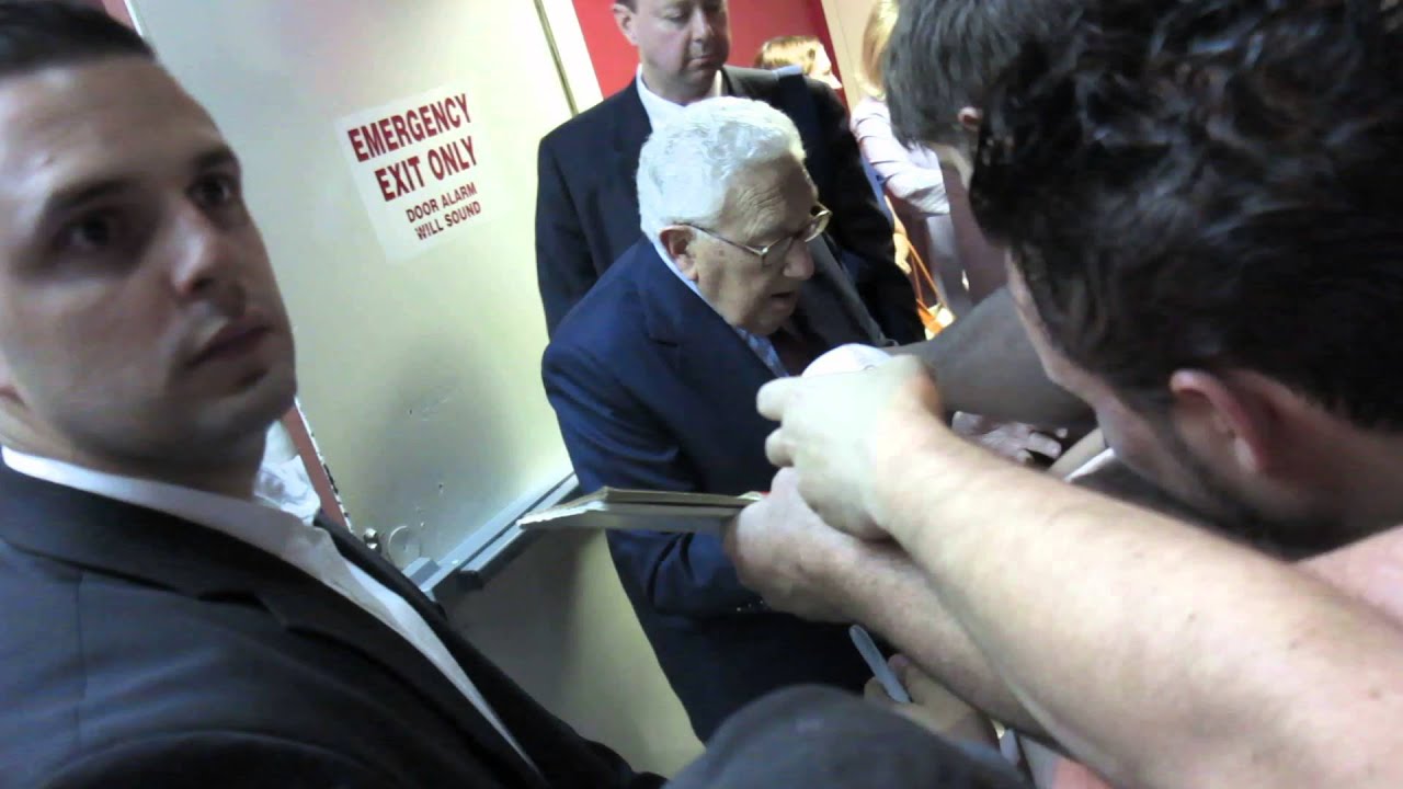Secretary of State Henry Kissinger signing autogaphs at Colbert Report