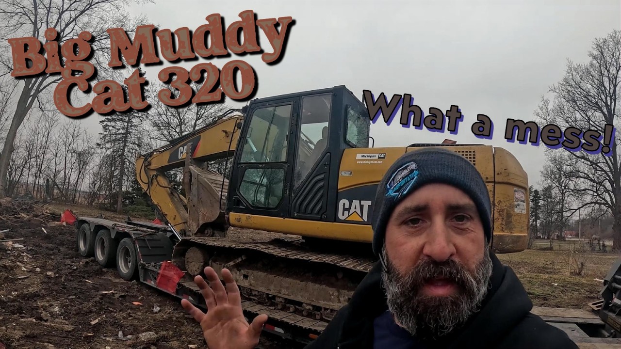 Heavy Haul Trucking: Muddy in Michigan! Loading a Cat 320 at a muddy jobsite!