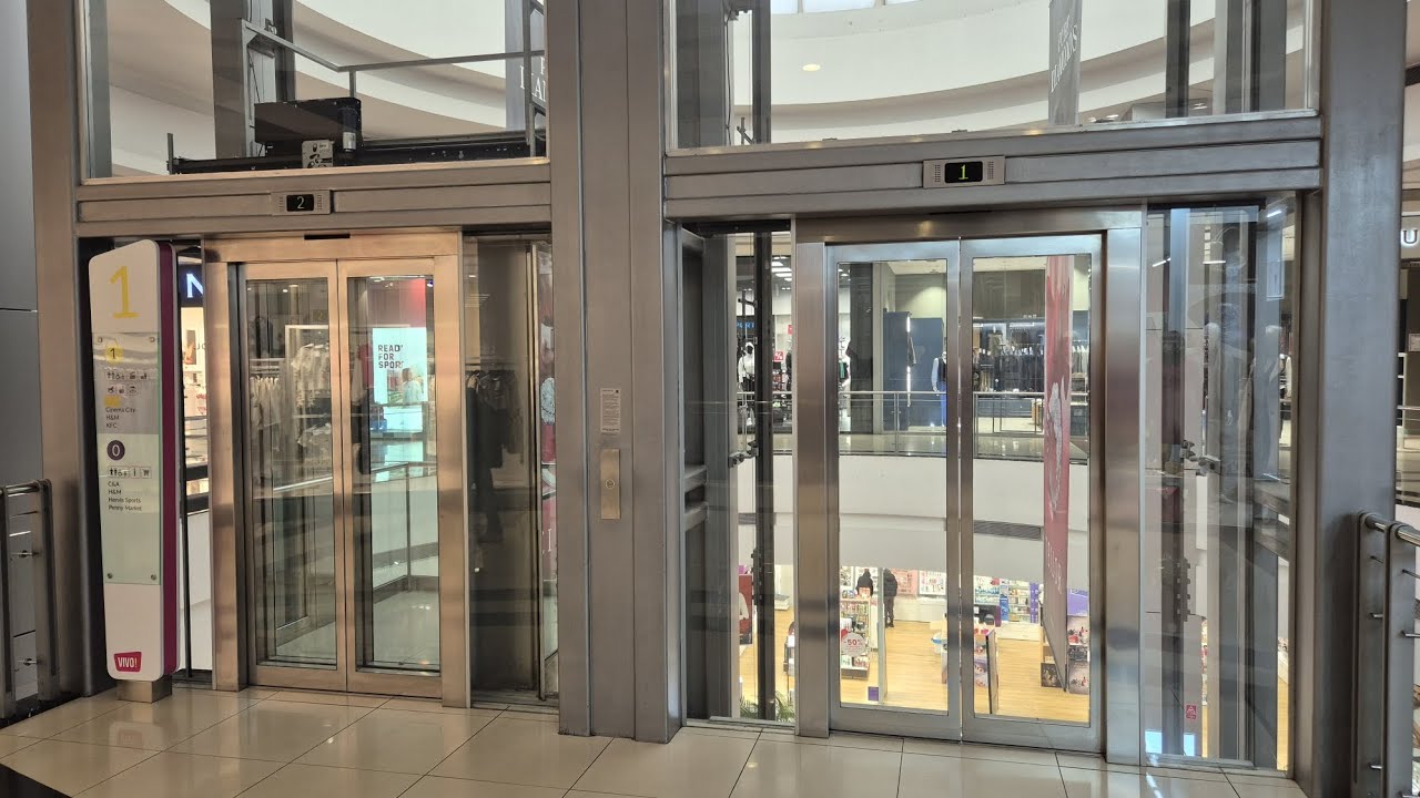 (Busted) Glass Schindler D-series elevators, at Vivo! MALL, Pitești, Romania