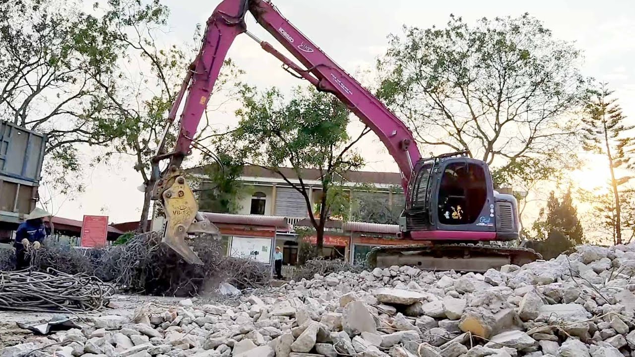 New project groundbreaking, KOBELCO excavator demolishes high-rise building, dump truck operates