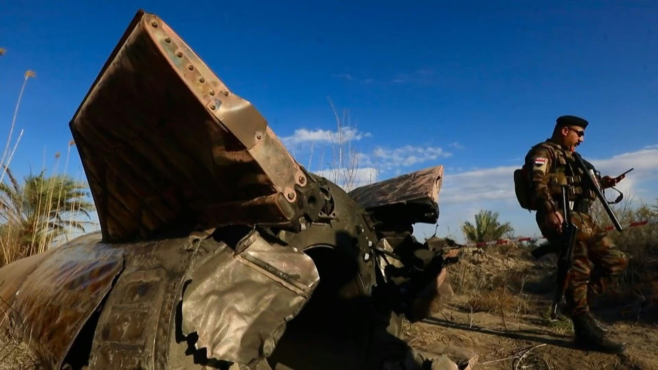 Iraqi officers inspect missile debris that landed in central Iraq | AFP