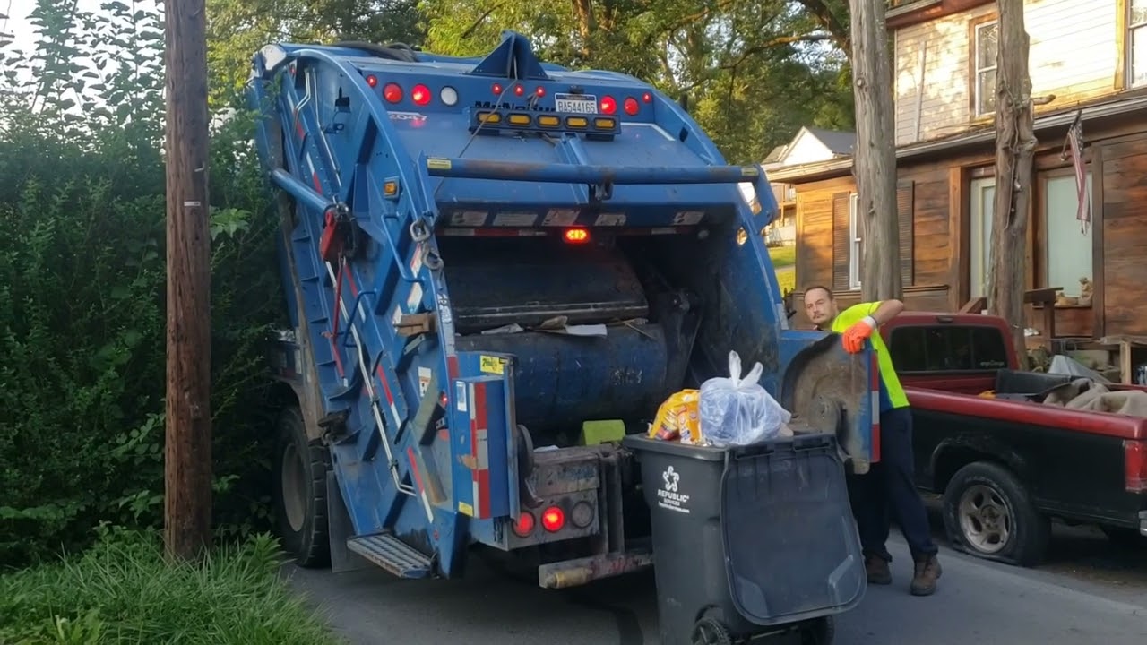 Republic Services Mack MRU Mcneilus rear loader on a residential trash route.