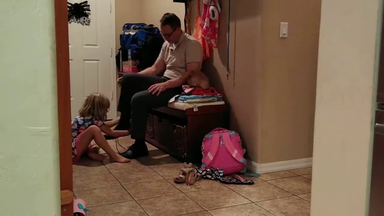 Taking off shoes from daddy's feet