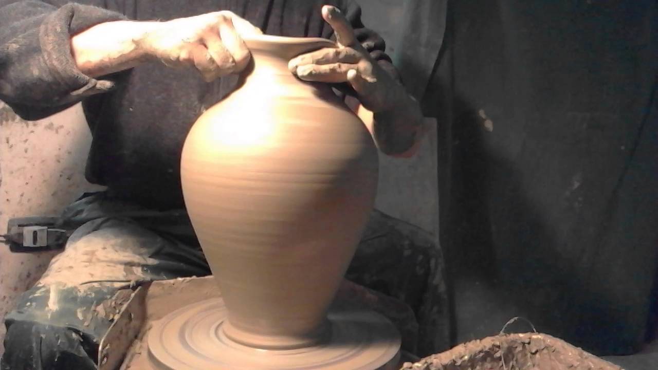Making / Throwing clay amphora on the potter wheel