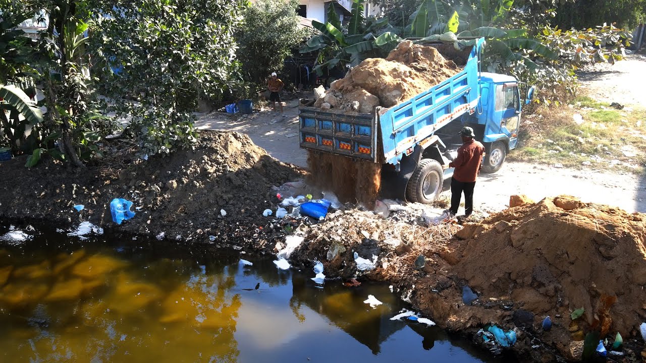 New work activities for filling the site with soil, water, plants and garbage