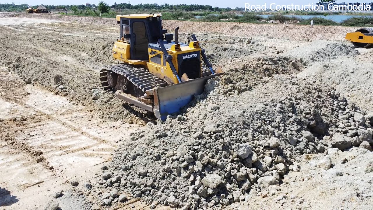 Skill Operator SHANTUI DH17c2 Bulldozer Spreading Soil And 12 Wheel Dump Truck Unloading