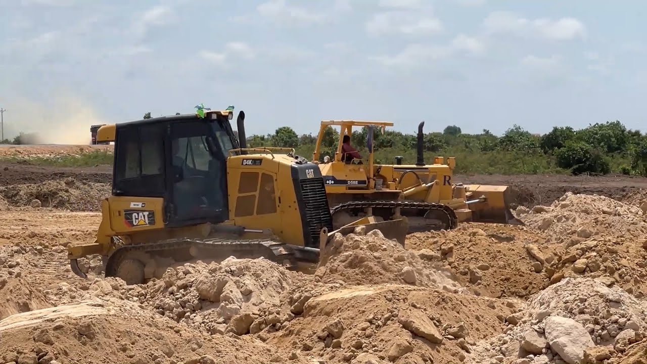 Extreme bulldozer pushing soil spreading for building road Cat D4k & Komatsu D58E