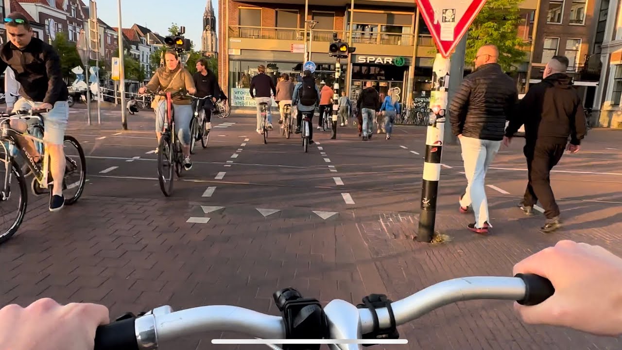 biking in beautiful Dutch summer evening through city center and to the lake