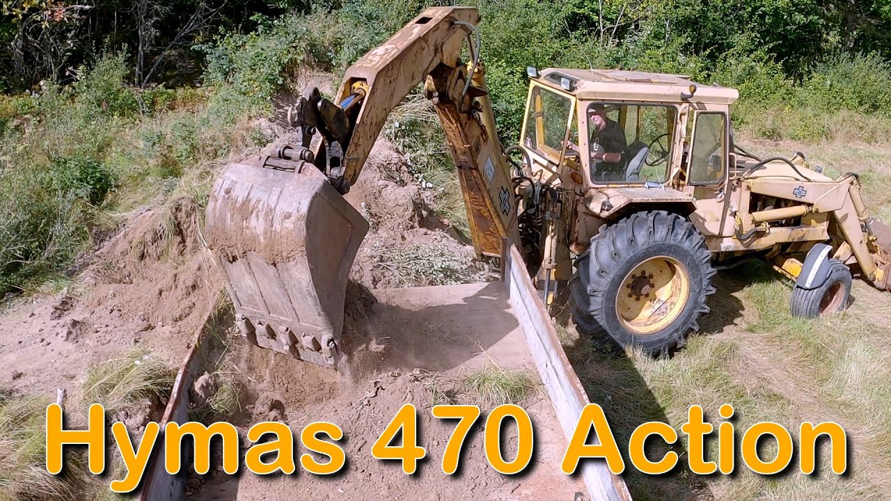 Hymas 470 Action (Traktorgrävare fyller ut mark)