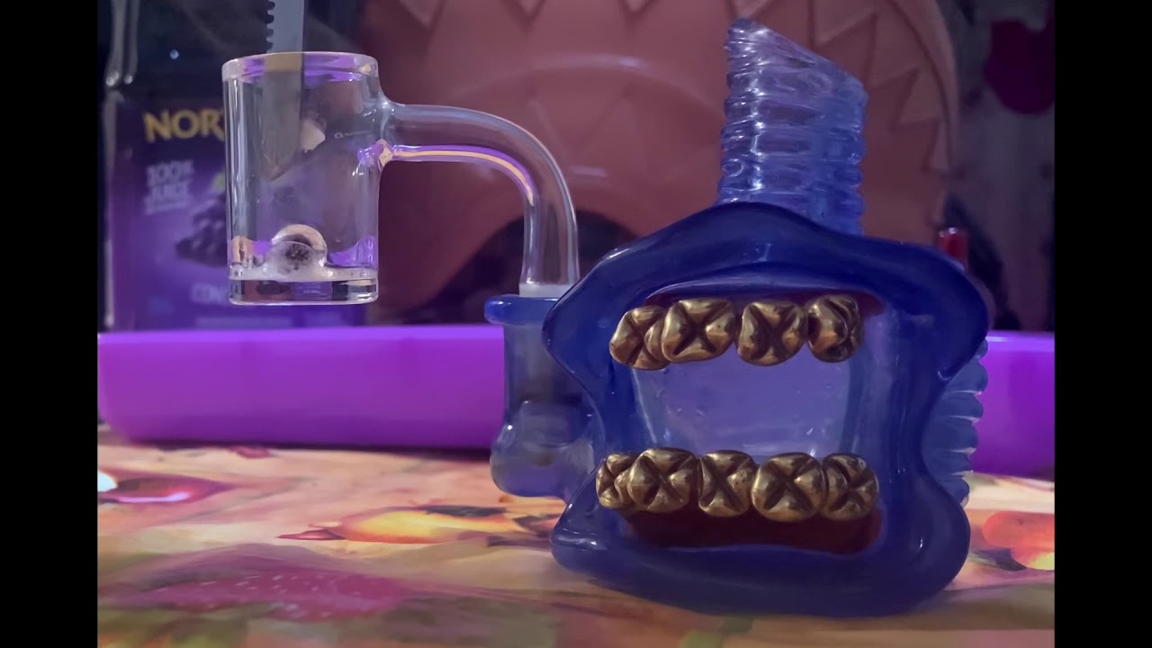 Wax dab out of fusion banger on a blue frosty fresh