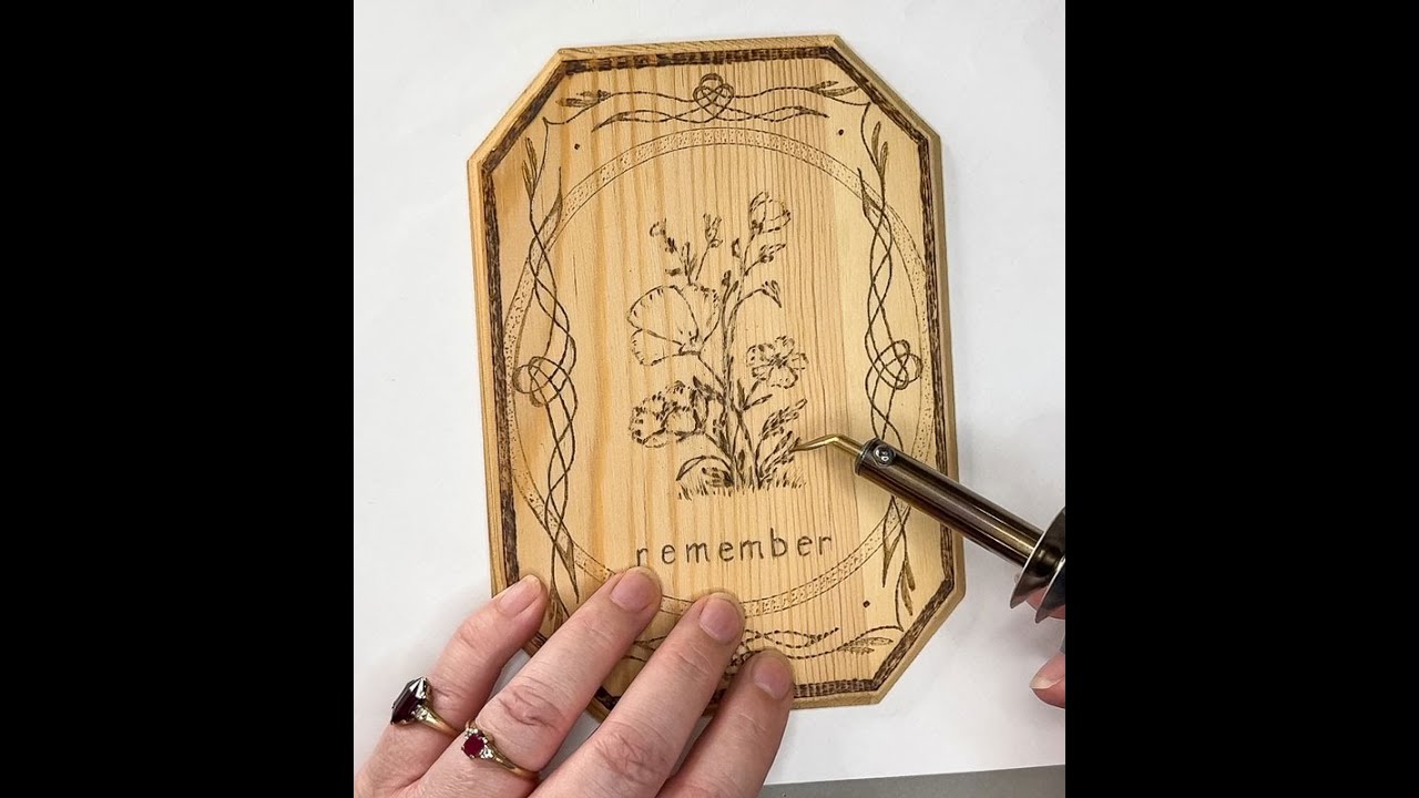 Wood-burning project: A poppy flower motif on a small wooden plaque