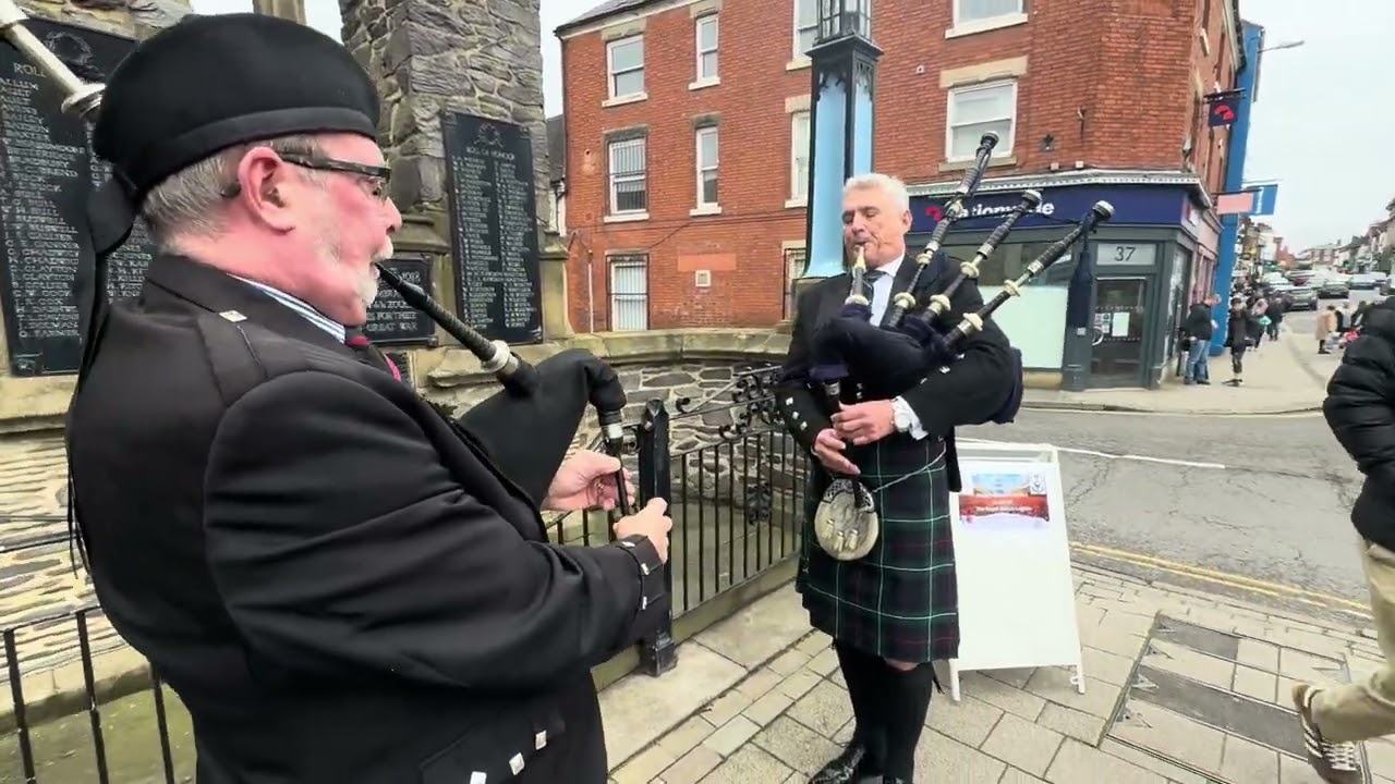 Kenny Horn and Michael Gordon playing the bagpipes in Ashby de la Zouch