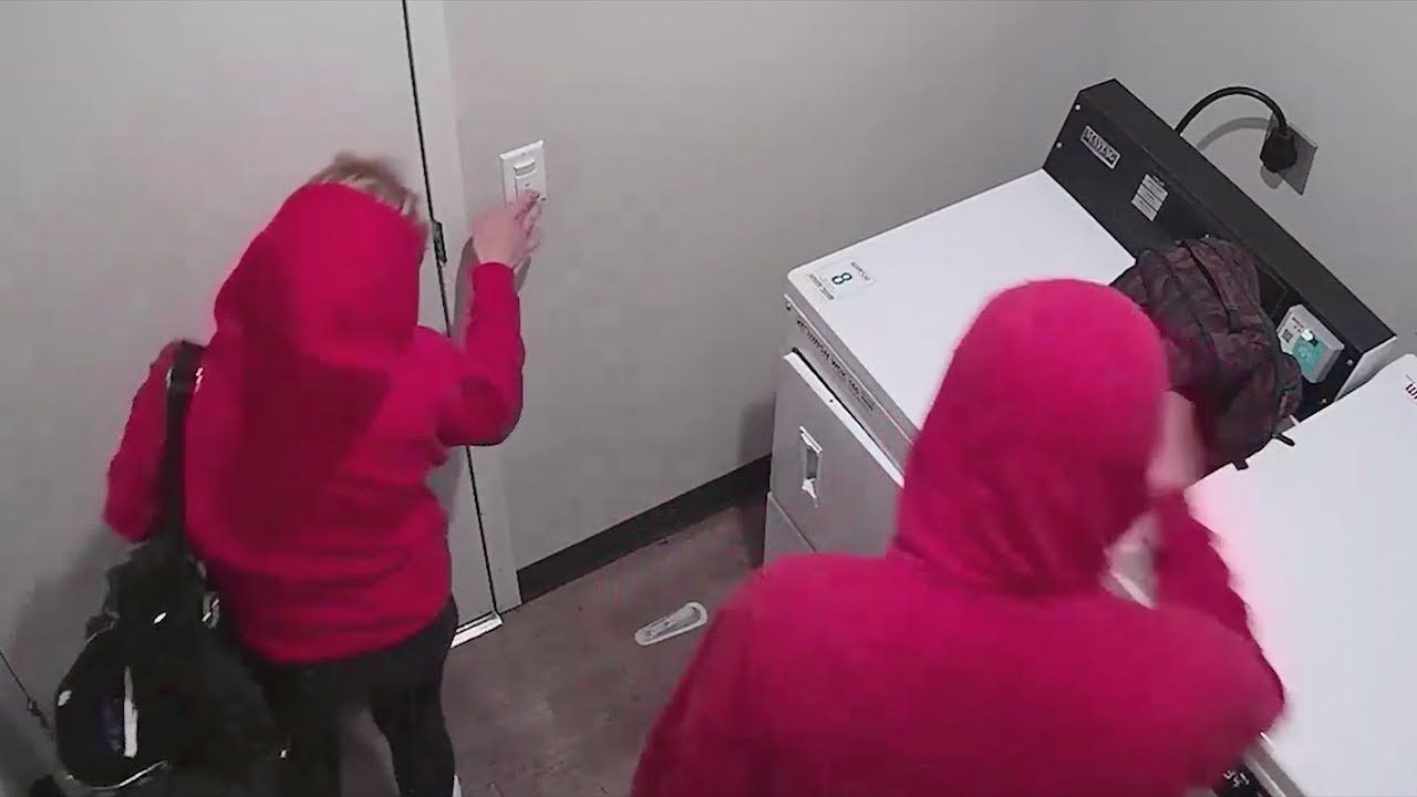 Two People Caught Tampering with Camera in Apartment Laundry Room