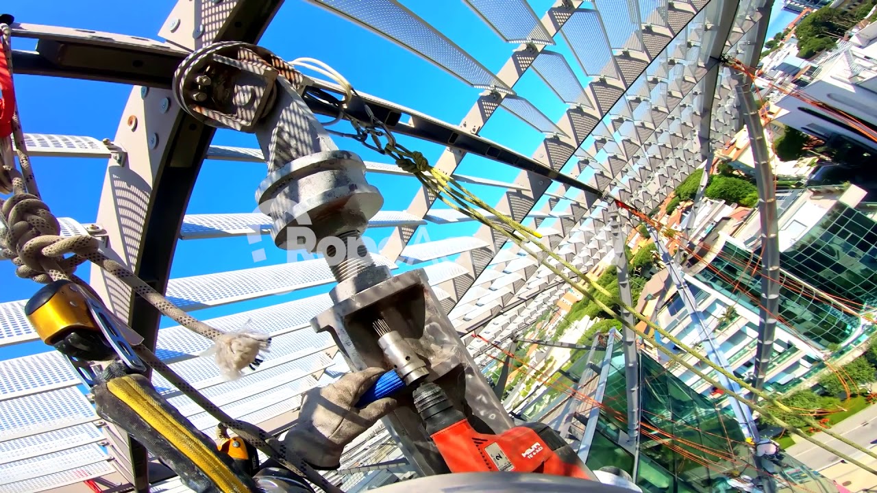 Rope access engineer does construction work on a commercial building