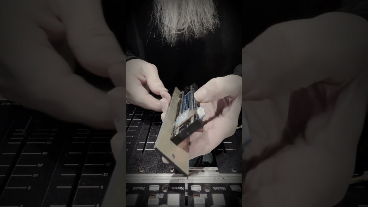 Cleaning faders on the Neotek Elite console at Realgrey Records