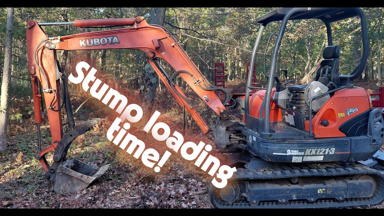 Check it out!!   Kubota KX121-3  loading up stump in dump trailer,  No problem for this machine!!