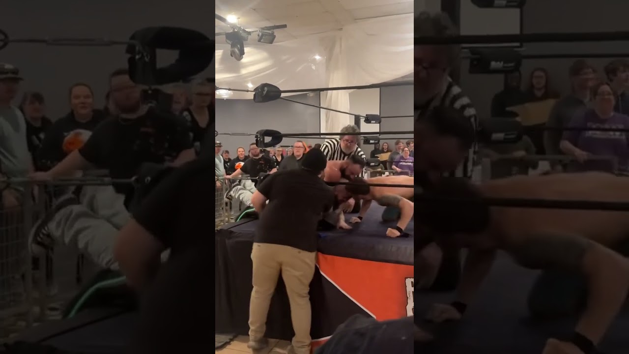 Fan jumps barricade after main event at wrestling show.