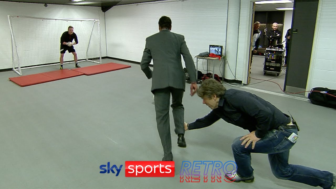 John Bishop trips Chris Kamara during a penalty shootout