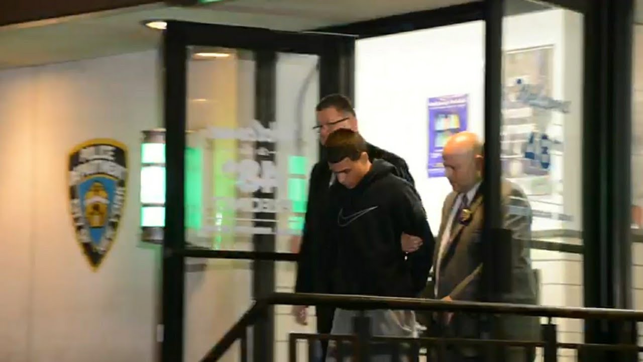 Kevin Alvarez being led from 48th Precinct
