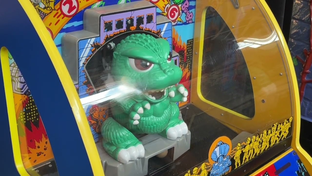Nate and Beth playing Godzilla Wars Jr. at an arcade