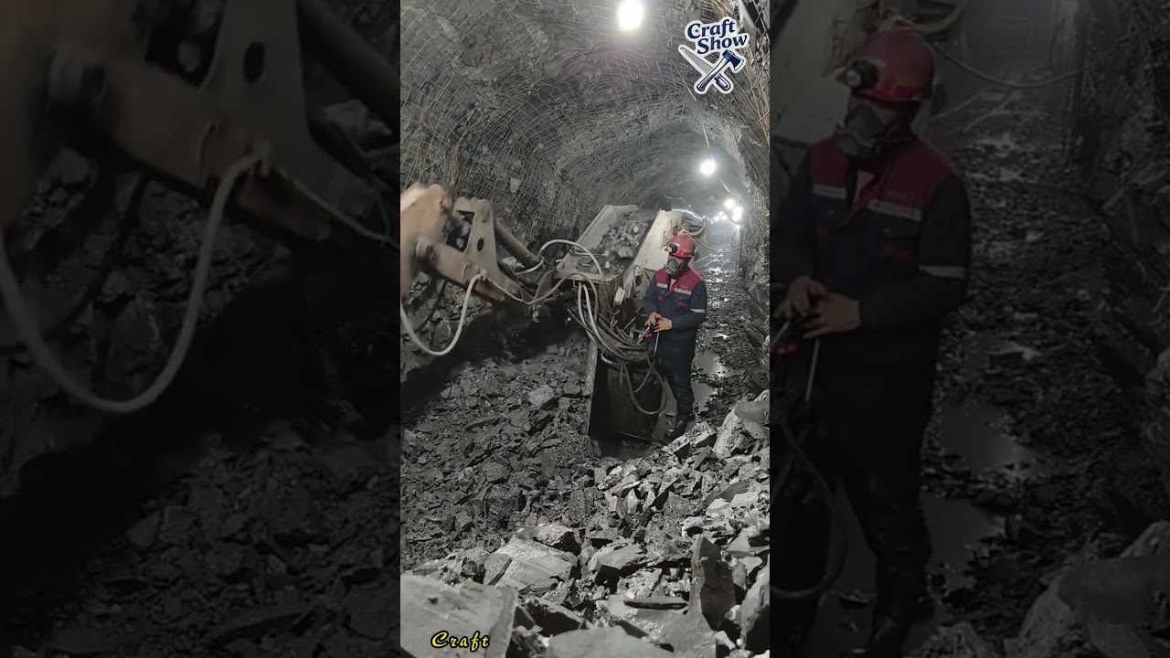 Workers operate excavators to dig tunnels