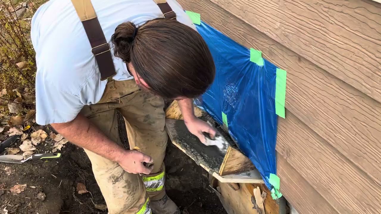 Aron fills the big holes in the foundation with concrete