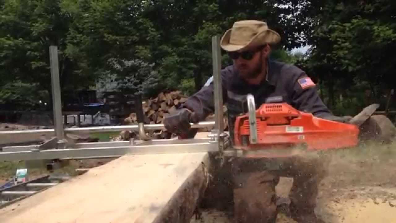 Milling lumber from pine logs on the homestead with an Alaskan chain saw mill and a Husqvarna 372xp
