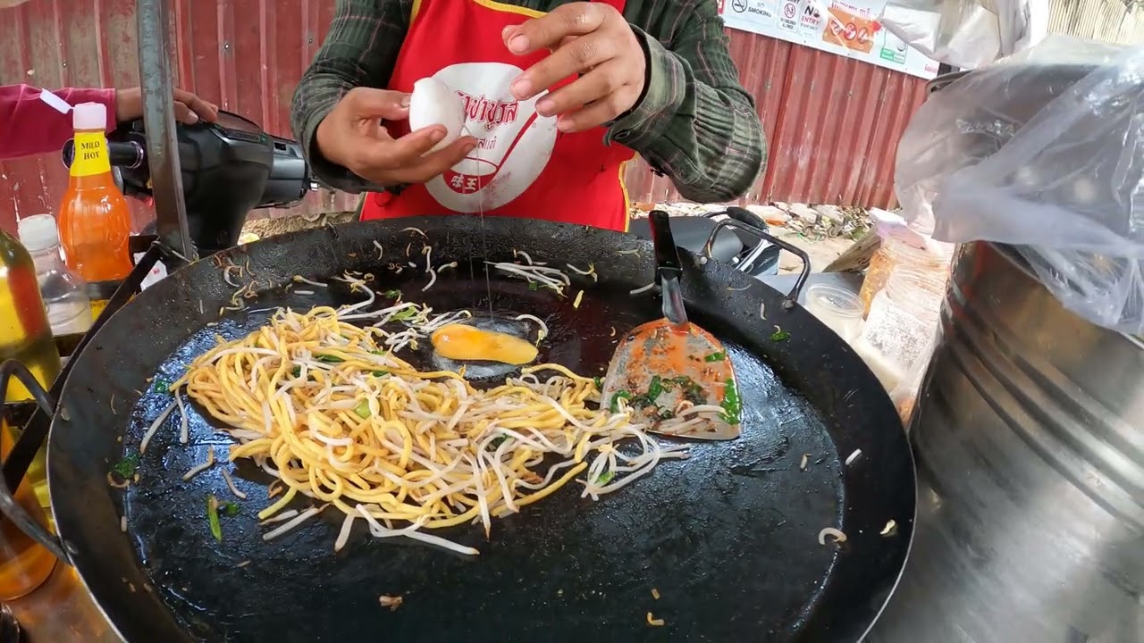 Asian Street Foods with Fry Yellow Noodles with Beef, Egg and Vegetables