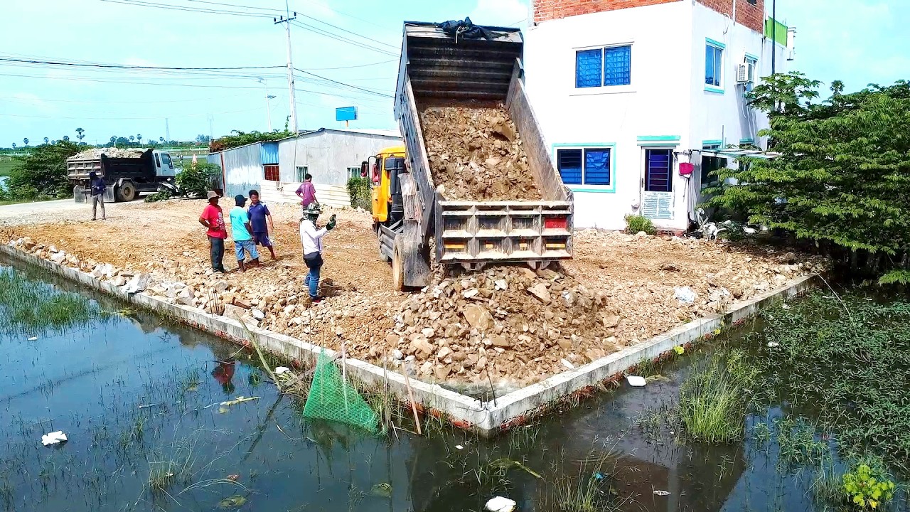 Finalize the plan to pour rocks into flooded areas at the rehabilitation site